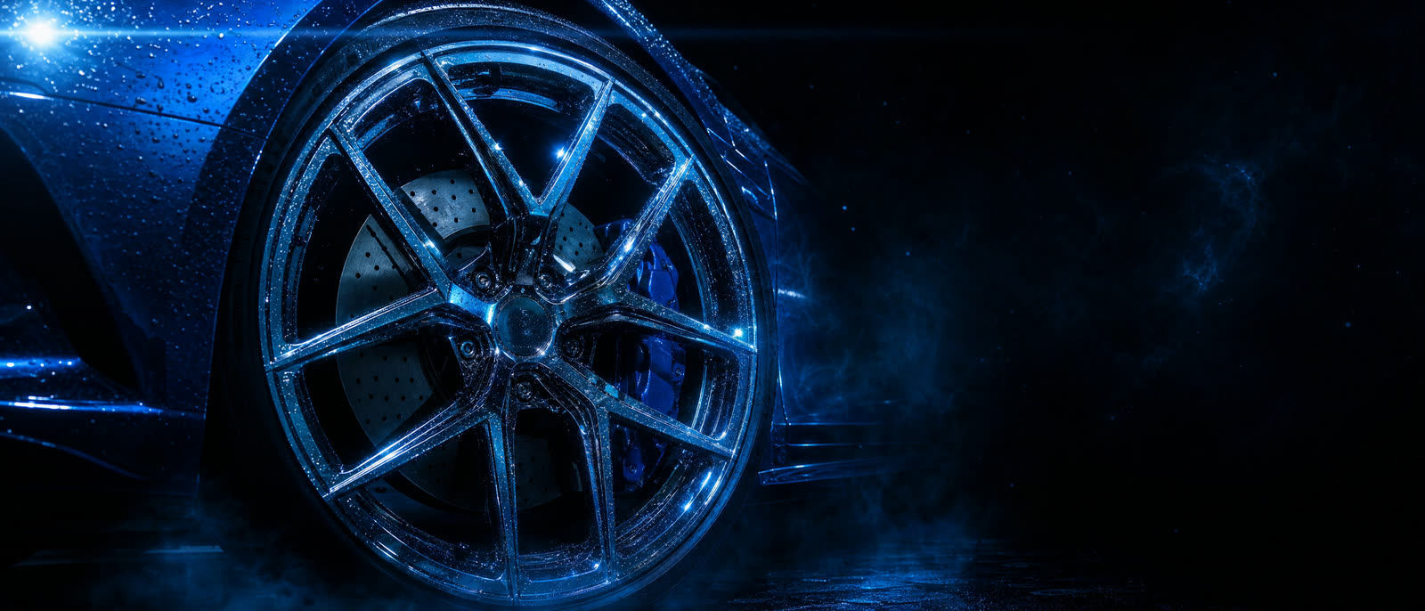 Extreme close-up of a polished luxury car wheel rim with brake caliper visible, water droplets glistening on the metal under cool cyan light